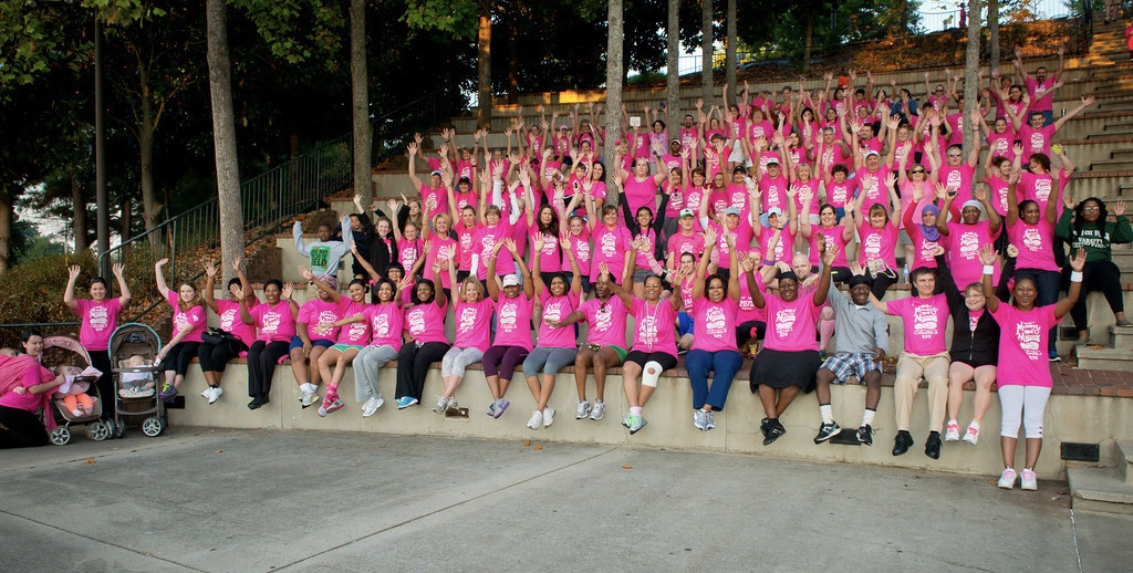 Team sitting in an amphitheater in a local park.