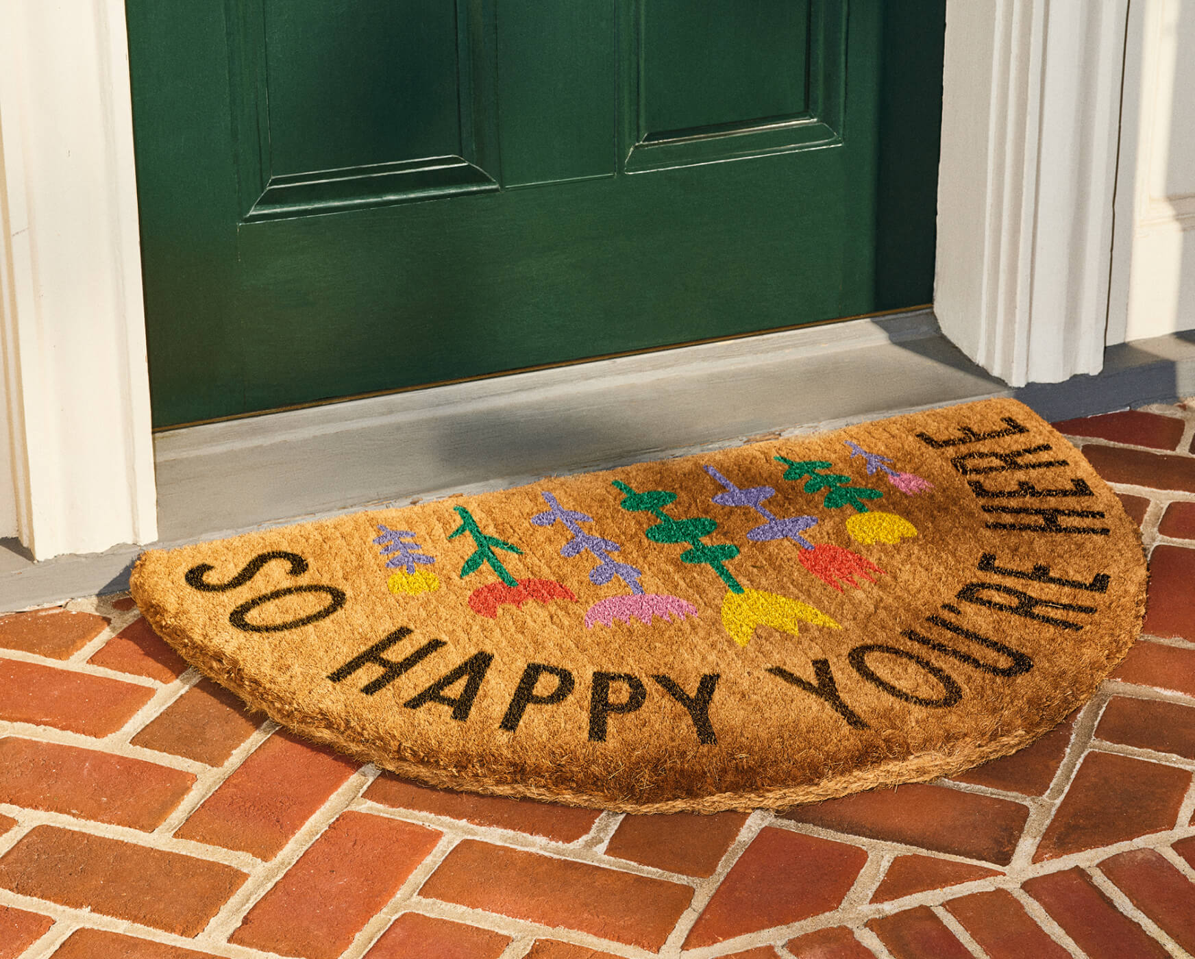 A welcome mat that reads 'So happy you're here.'