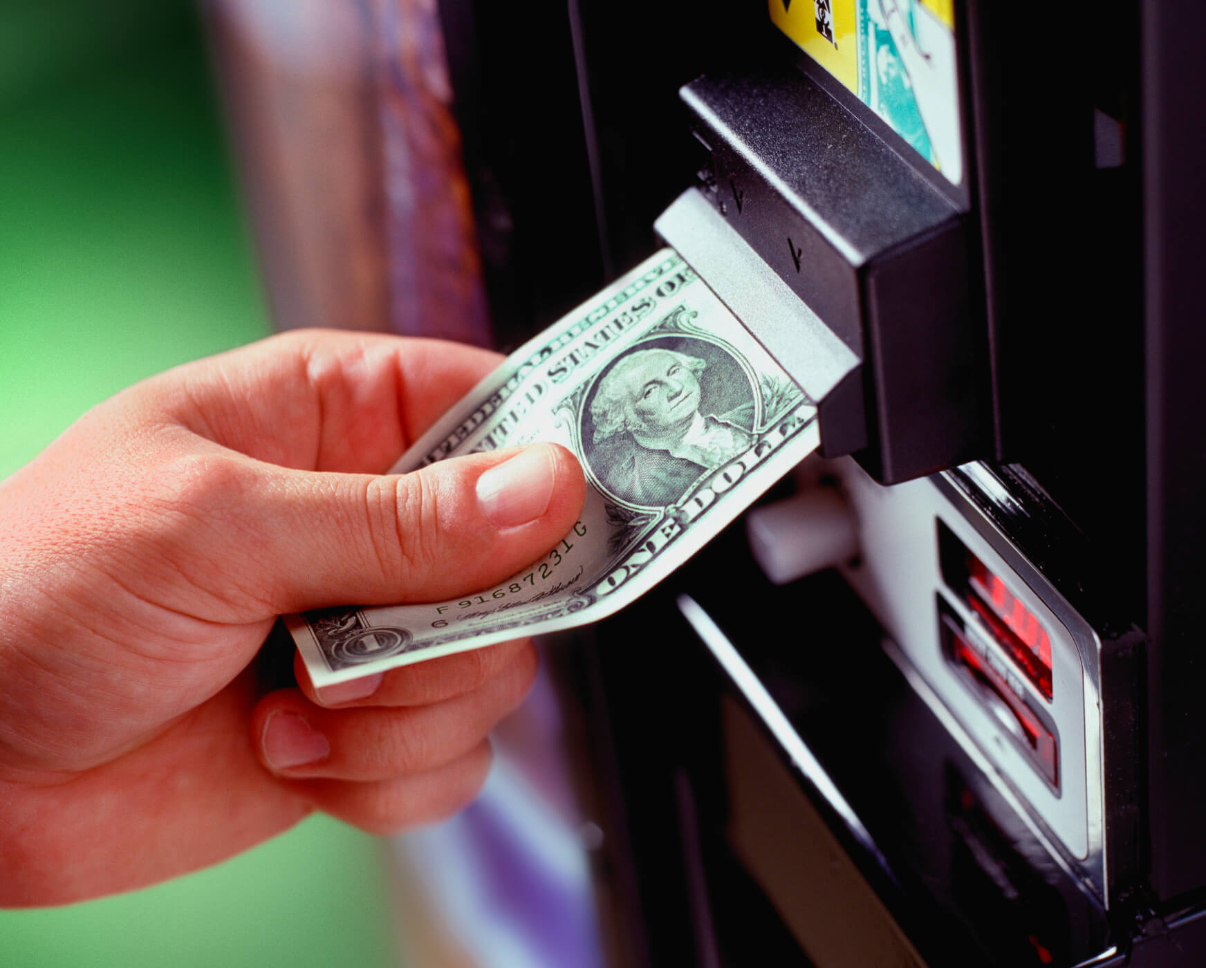Vintage yellow rotary phone on a wooden table.